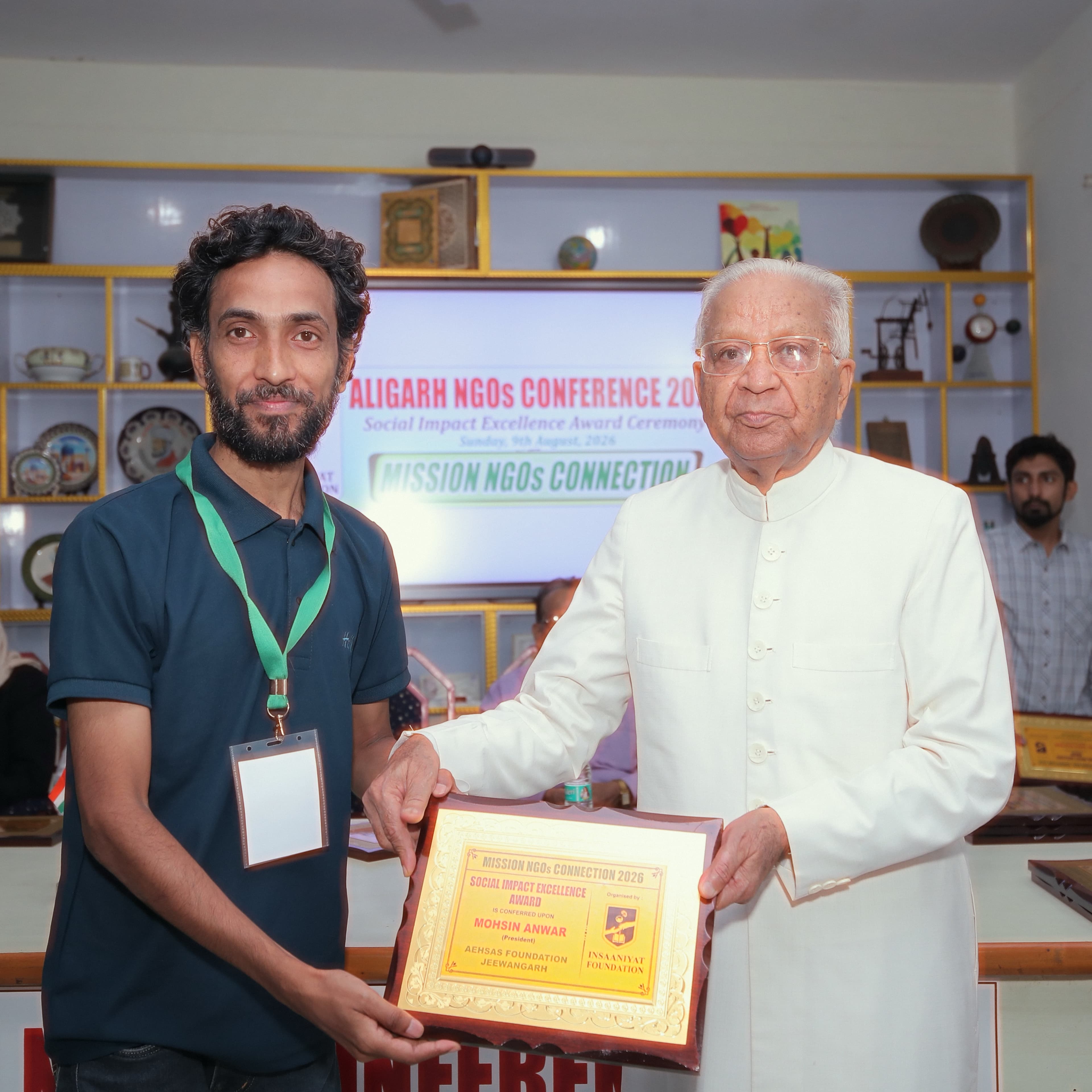 AEHSAS Foundation President Mohsin Anwer receiving the Social Impact Excellence Award plaque at the Aligarh NGOs Conference 2026